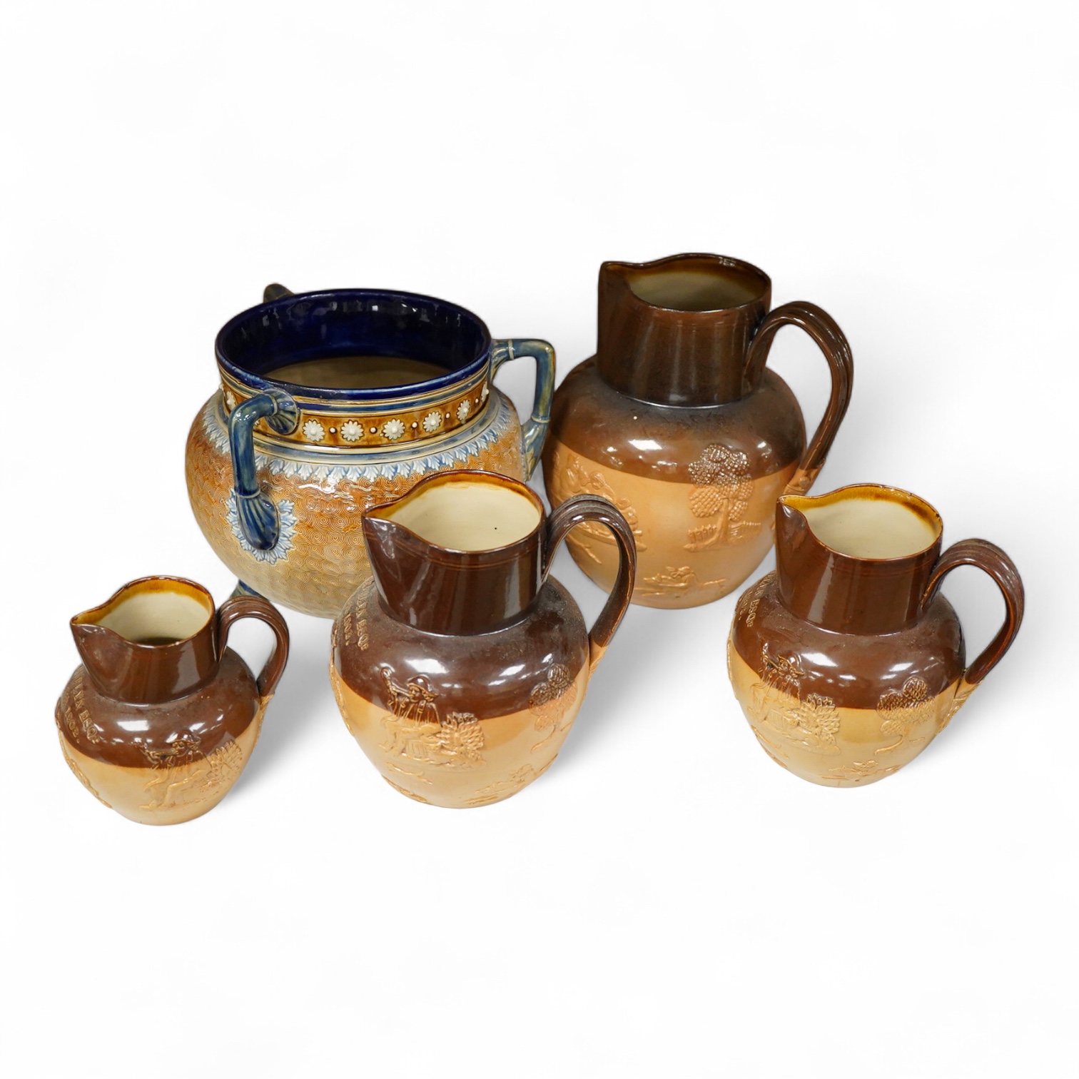 Four graduated Royal Doulton harvest jugs and a Royal Doulton Lambeth three footed jardiniere- 17cm high